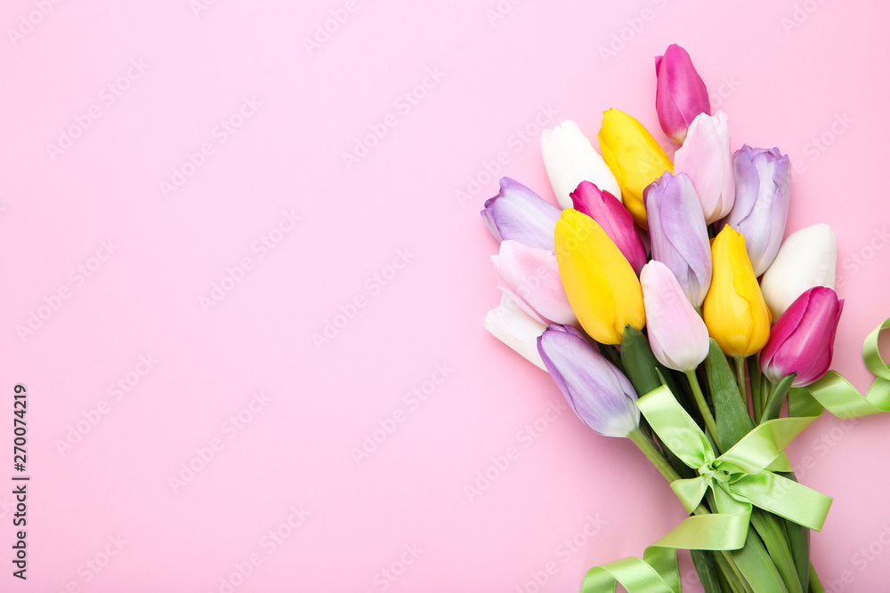 Bouquet of tulip flowers with ribbon on pink background Bouquet of tulip flowers with ribbon on pink background