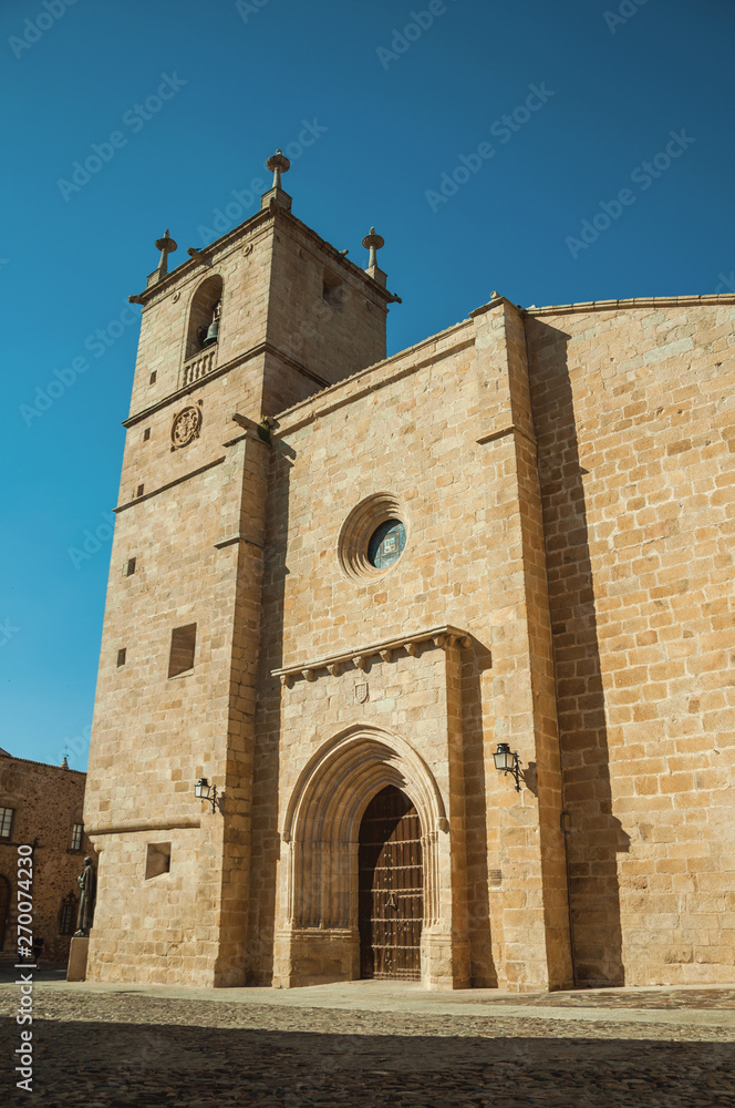 The gothic Santa Maria Cathedral with big wooden door at Caceres