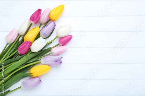 Bouquet of tulip flowers on white wooden table