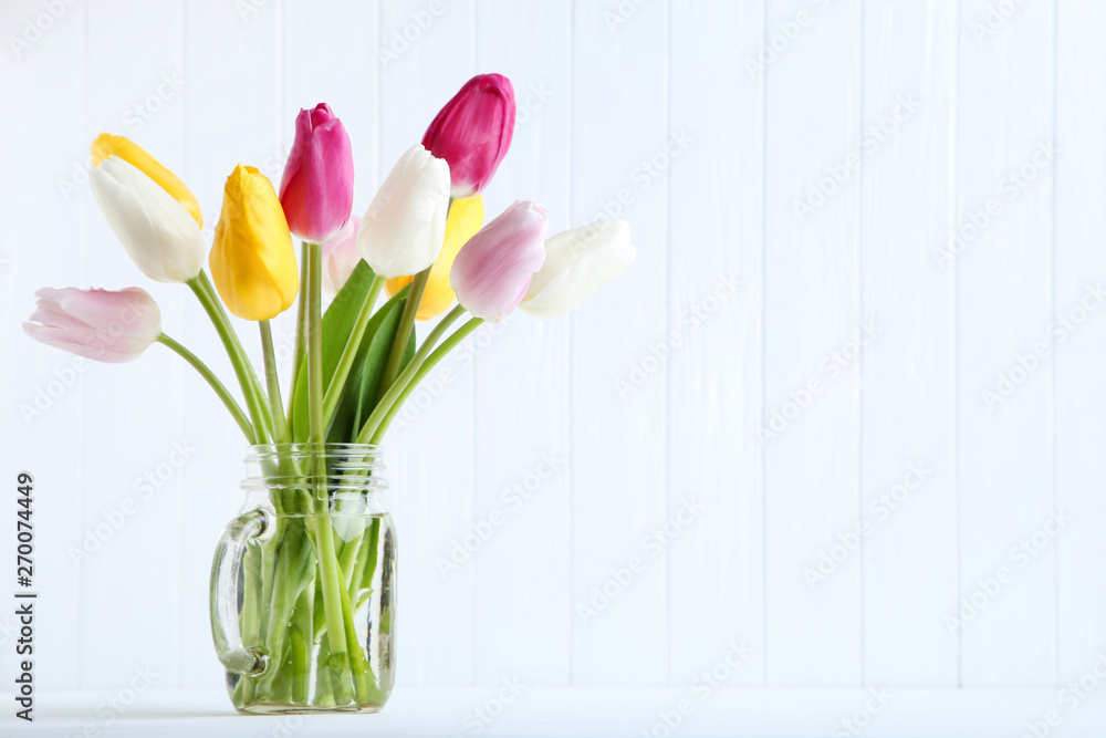 Bouquet of tulip flowers in glass jar on white background Bouquet of tulip flowers in glass jar on white background