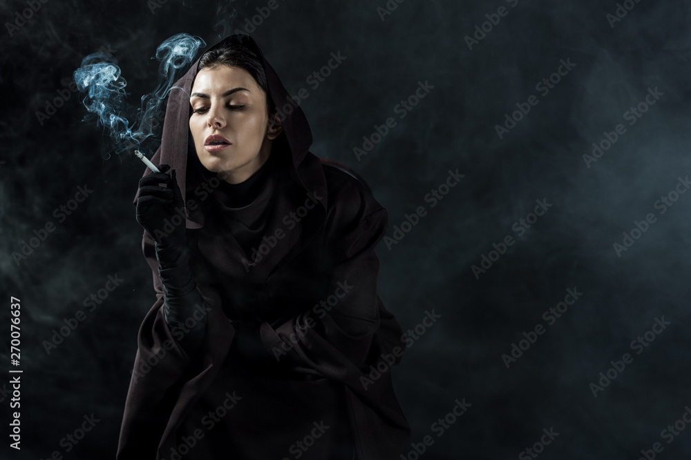 woman in death costume smoking cigarette on black woman in death costume smoking cigarette on black