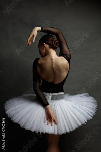 Obraz na płótnie Young beautiful ballerina is posing in studio