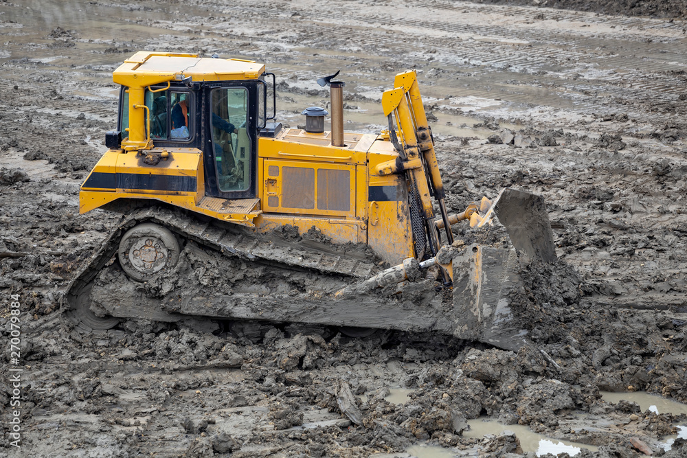 Dozer pushing pile of dirt