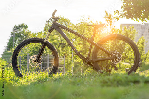 Modern bicycle. Black mountain bike at sunset. Trail bike. Hardtail enduro mtb.  photo