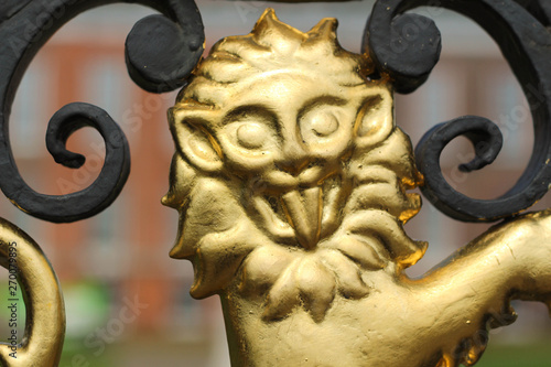 London. Golden Gate located on the side of Kensington Palace with palace in background during day of Spring