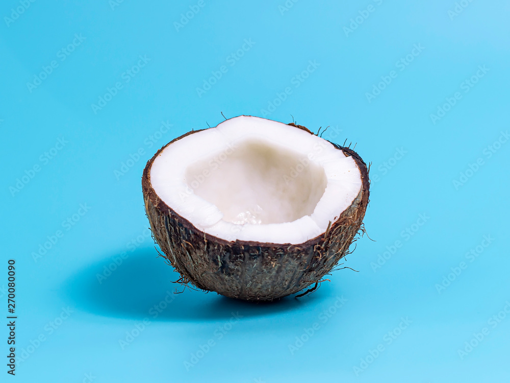 Closeup of coconut on blue background. Summer background. Closeup of coconut on blue background. Summer background.