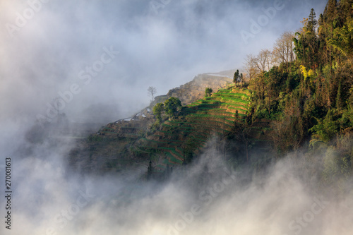 Honghe Yuanyang  Samaba Rice Terrace Fields - Baohua township  Yunnan Province China. Sama Dam Multi-Color Terraces - grass  mud construction layered terraces filled with water  blue sky reflection