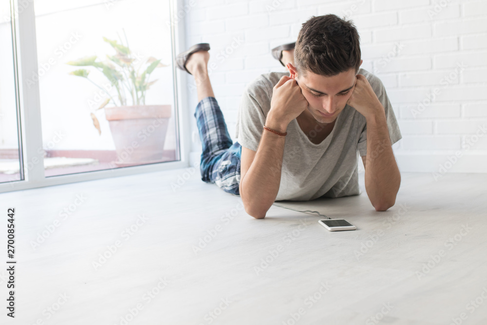 young man with mobile phone at home