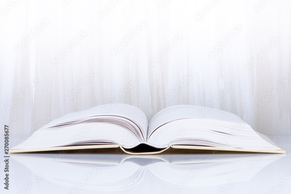Open book on light table with reflection Open book on light table with reflection