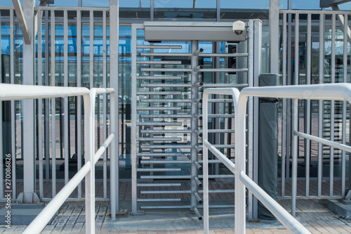 Footbal arena security entrance gate - secured turnstiles before inspection at stadium. 