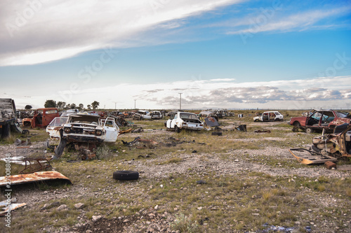 Old damaged cars on the junkyard waiting. Cemetery of cars.