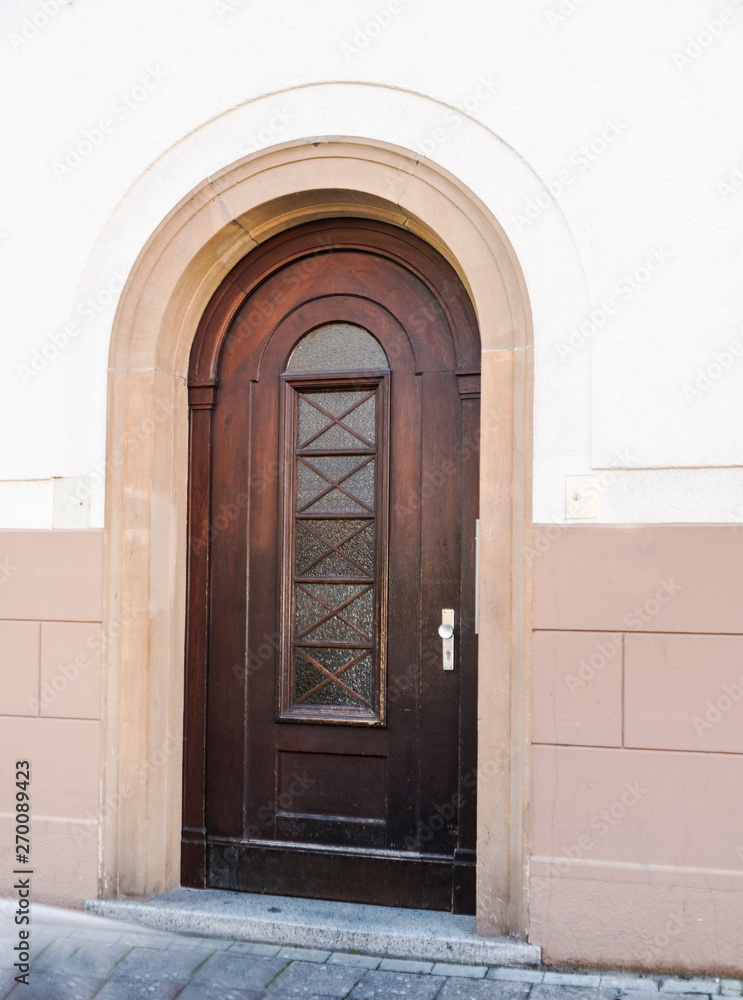 brown wooden arched entrance doors