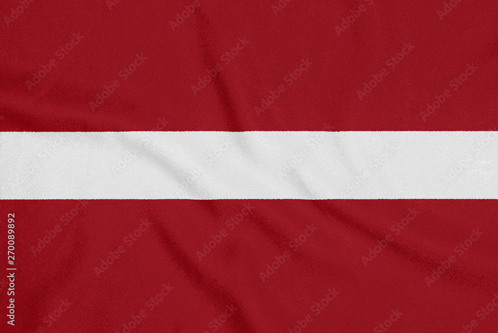 Flag of Latvia on textured fabric. Patriotic symbol Flag of Latvia on textured fabric. Patriotic symbol