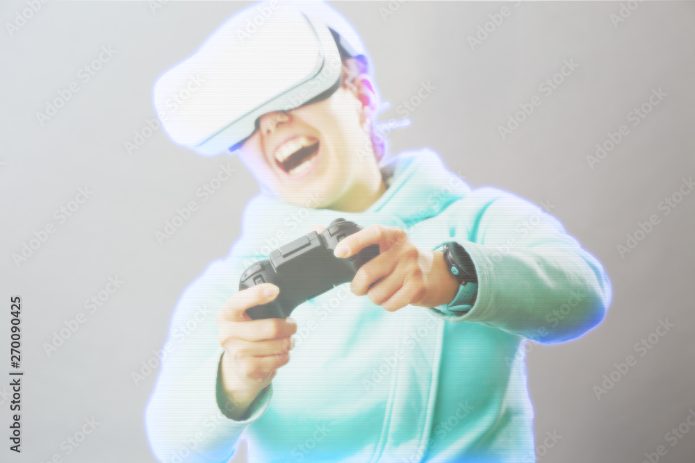 Woman with virtual reality headset is playing game. Image with hologram effect. Woman with virtual reality headset is playing game. Image with hologram effect.