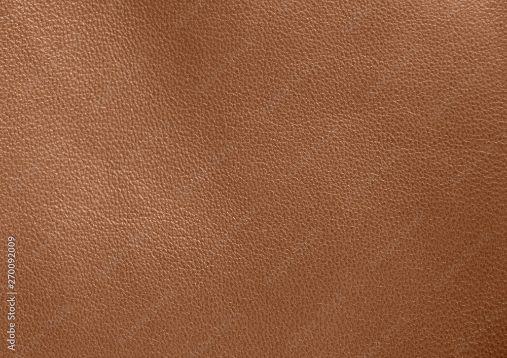 Texture of genuine leather. Brown background. The structure of the leather material close-up. Texture of genuine leather. Brown background. The structure of the leather material close-up.