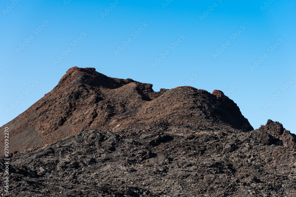 Timanfaya National Park, mountains of fire Lanzarote, Canary Islands, Spain. Unique panoramic view of spectacular lava river flows from a huge volcano crater creates martian landscape on planet earth. Timanfaya National Park, mountains of fire Lanzarote, Canary Islands, Spain. Unique panoramic view of spectacular lava river flows from a huge volcano crater creates martian landscape on planet earth.