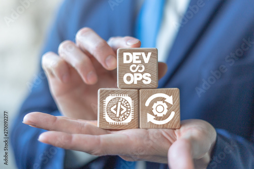 Devops agile software development operations concept on a wooden blocks in a businessman hands.
