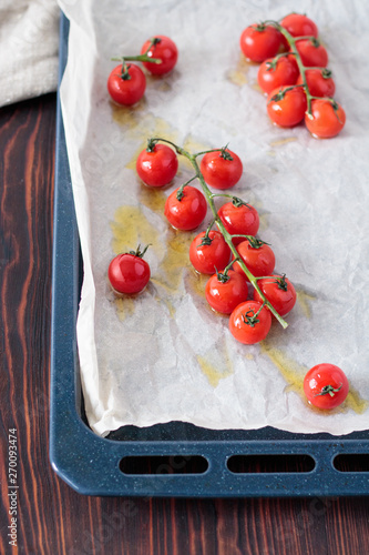 Fresh red tomatoes on a branch of with basil. 