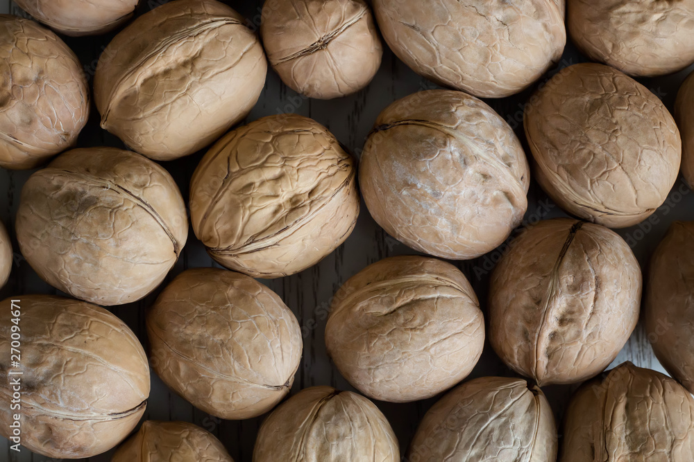 Ripe whole walnuts close-up. Natural background. Top view. Ripe whole walnuts close-up. Natural background. Top view.