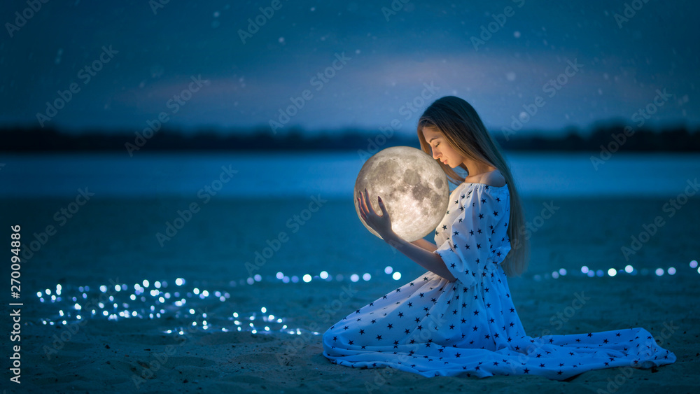 Beautiful attractive girl on a night beach with sand and stars hugs the moon, Artistic Photography - obrazy, fototapety, plakaty 