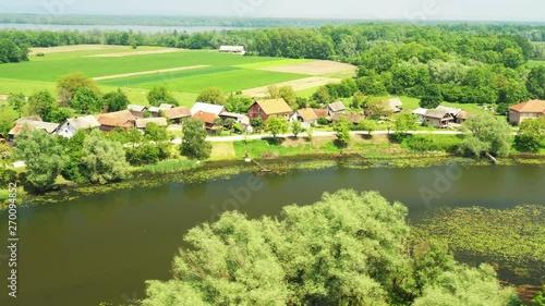 Rural Croatia, countryside landscape in nature park Lonjsko polje from air, panoramic view of traditional village Muzilovcica, circle fly  photo