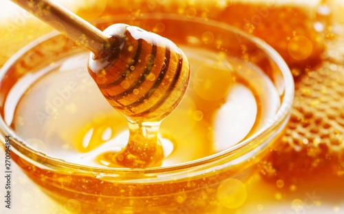Honey with spoon in glass bowl