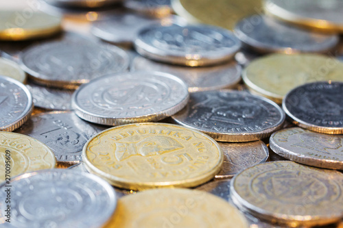 Coins of the different countries. Close up. Side view. Selective focus