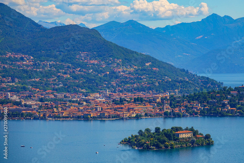 AERIAL: Scenic view of a coastal town and islet in a beautiful Italian lake.