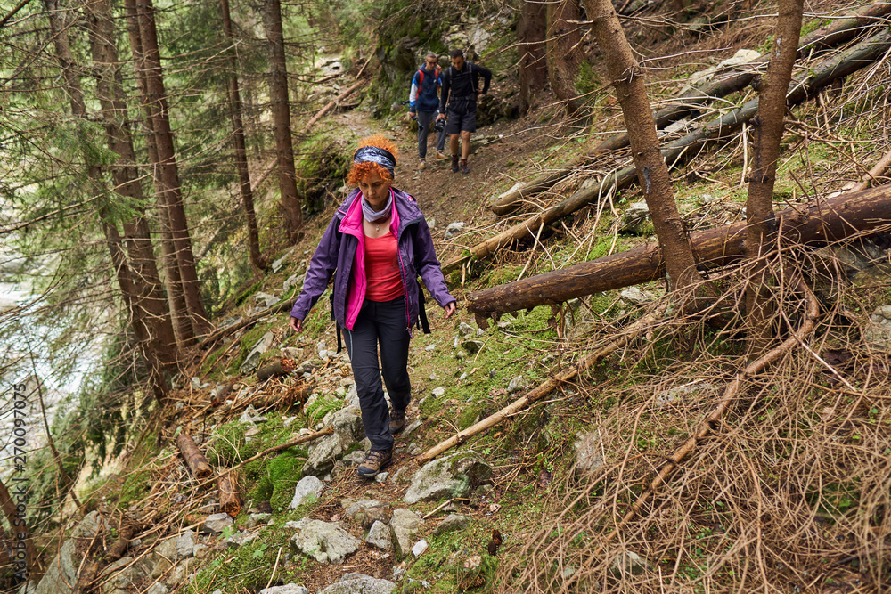 Backpackers on a hiking trail Backpackers on a hiking trail