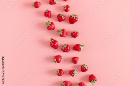 Strawberries on pink background. Strawberries berries pattern. Creative food concept. Flat lay, top view, copy space 