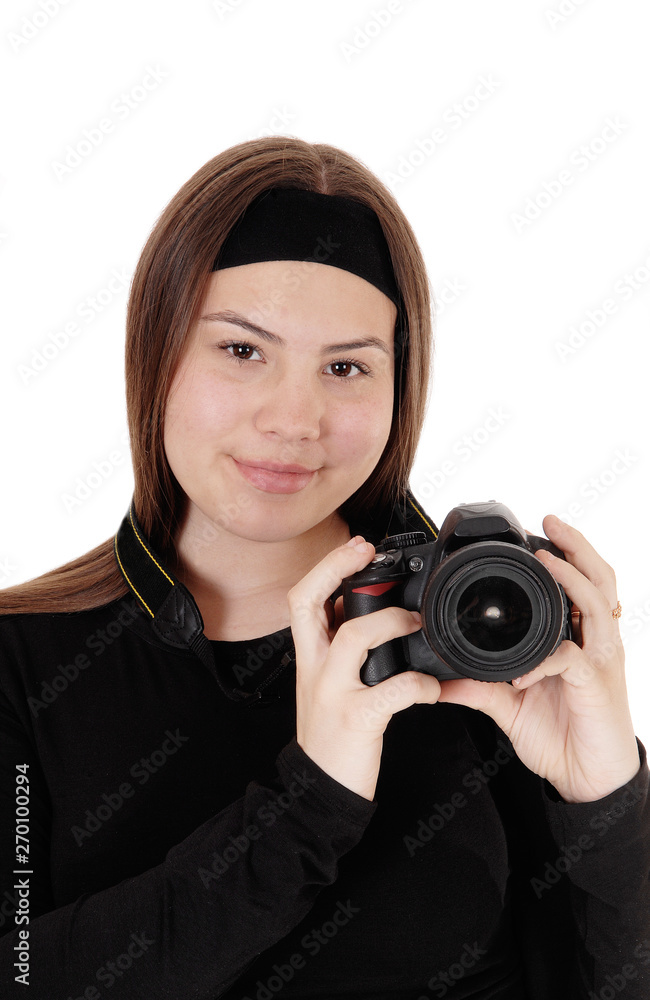 Teen girl holding a camera and taking pictures Teen girl holding a camera and taking pictures