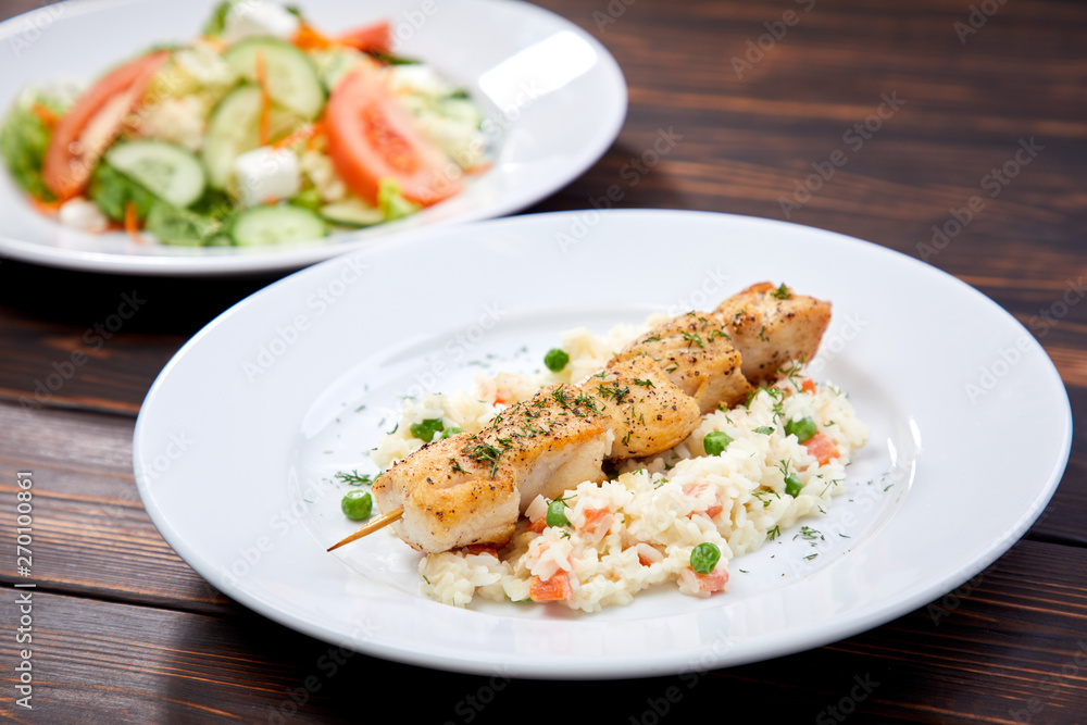 chicken kebab with rice and vegetables on the wooden background chicken kebab with rice and vegetables on the wooden background