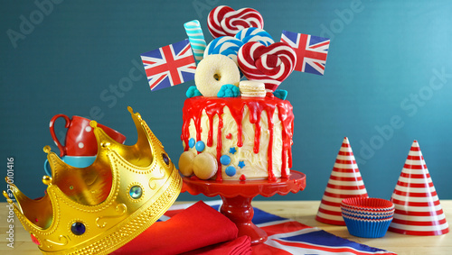 Fotografie UK on-trend candyland fantasy drip cake with red, white and blue decorations, lollipops and flags