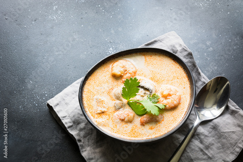 Tom yam kung spicy thai soup with shrimp, seafood, coconut milk and chili pepper. Copy space