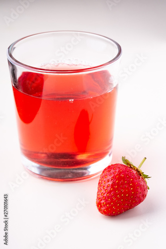 Wallpaper Mural One strawberry with compote drink in glass isolated on white background Torontodigital.ca