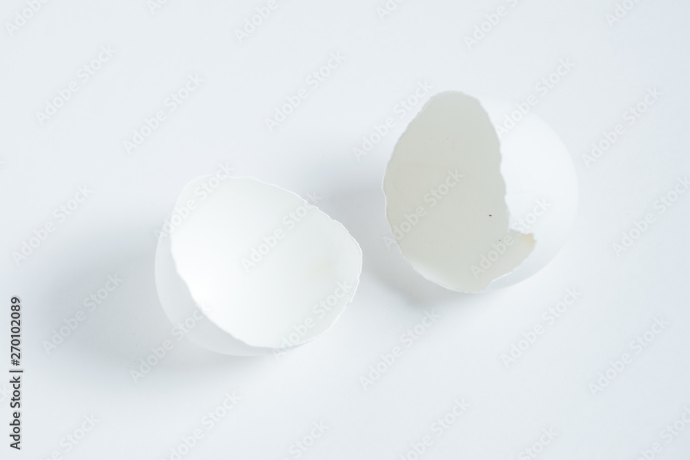 An empty broken egg shell on a white background.