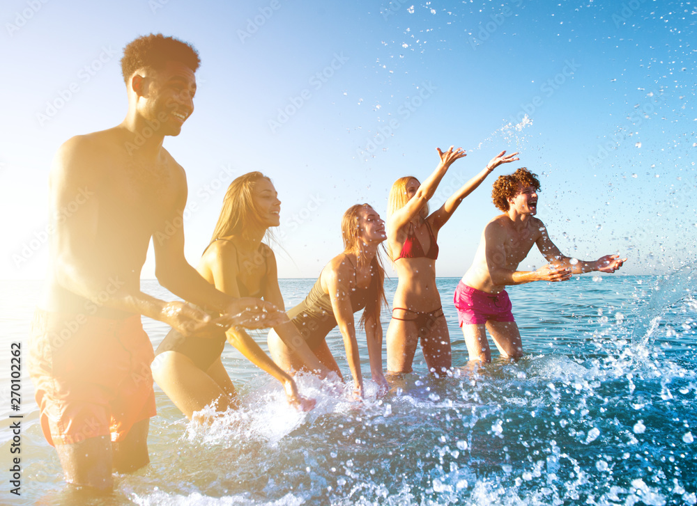Group of friends having fun at the beach with water sea Group of friends having fun at the beach with water sea
