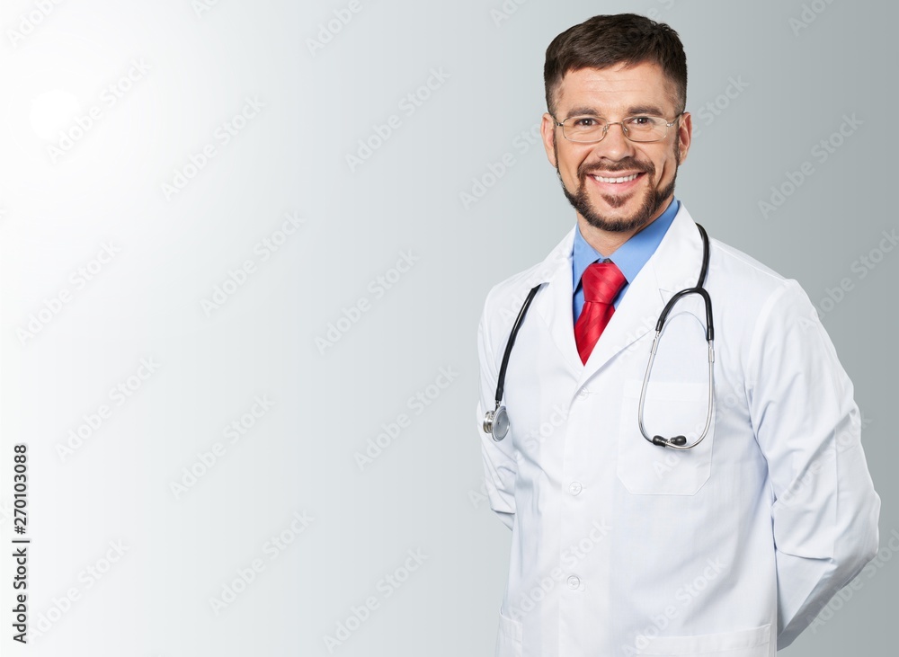 Fototapeta premium Male doctor with stethoscope on hospital background