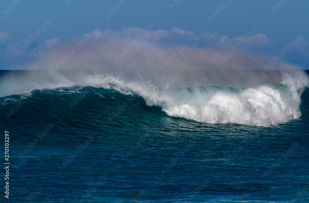 Beautiful Breaking Wave with rainbow colors in Hawaii