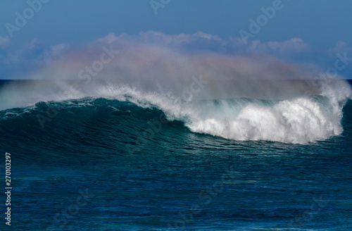 Beautiful Breaking Wave with rainbow colors in Hawaii