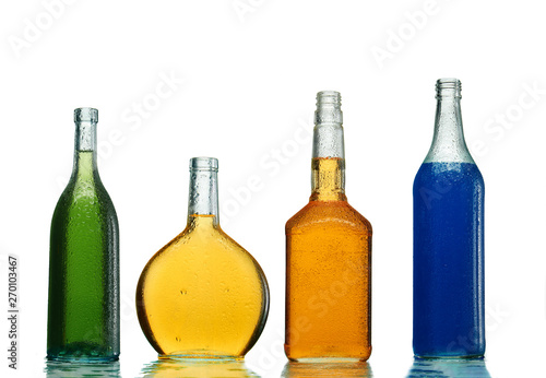 Various alcoholic drinks in transparent bottles