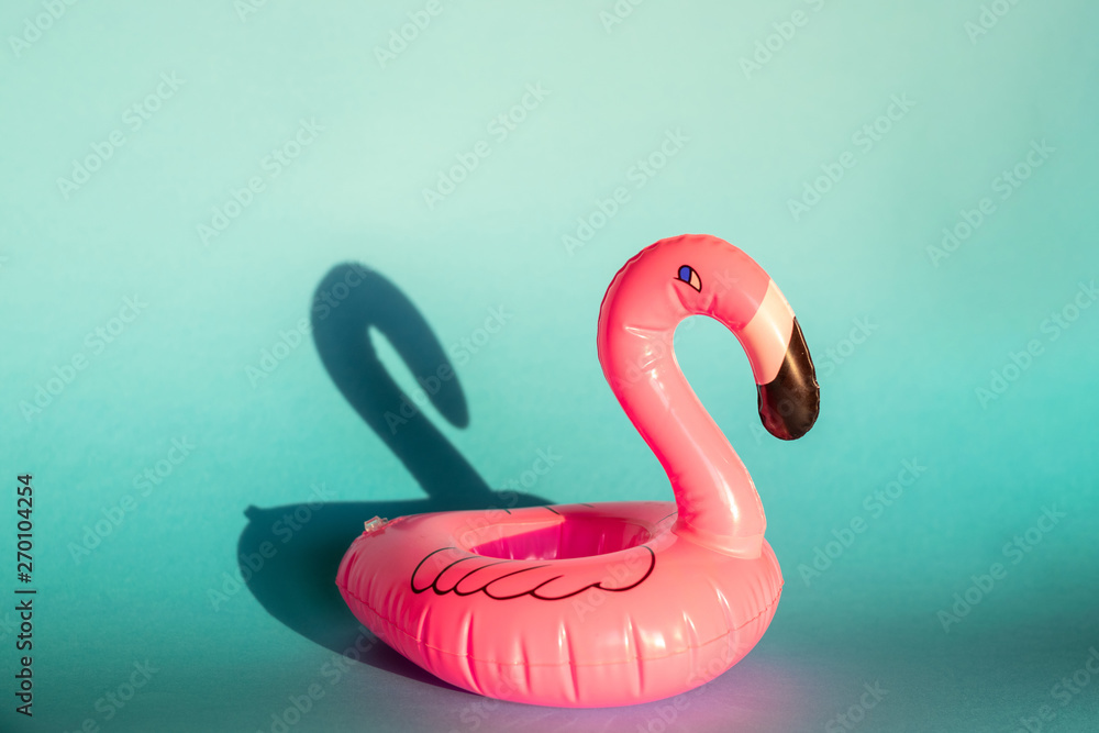 Giant inflatable Flamingo on a blue background, pool float party, trendy summer concept Giant inflatable Flamingo on a blue background, pool float party, trendy summer concept