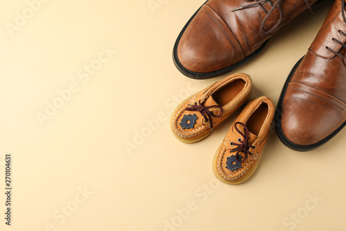 Принти на полотні Brown leather shoes and children's shoes on color background, space for text and