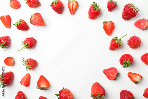 Flat lay composition with strawberries on white background, space for text. Summer sweet fruits and berries photo