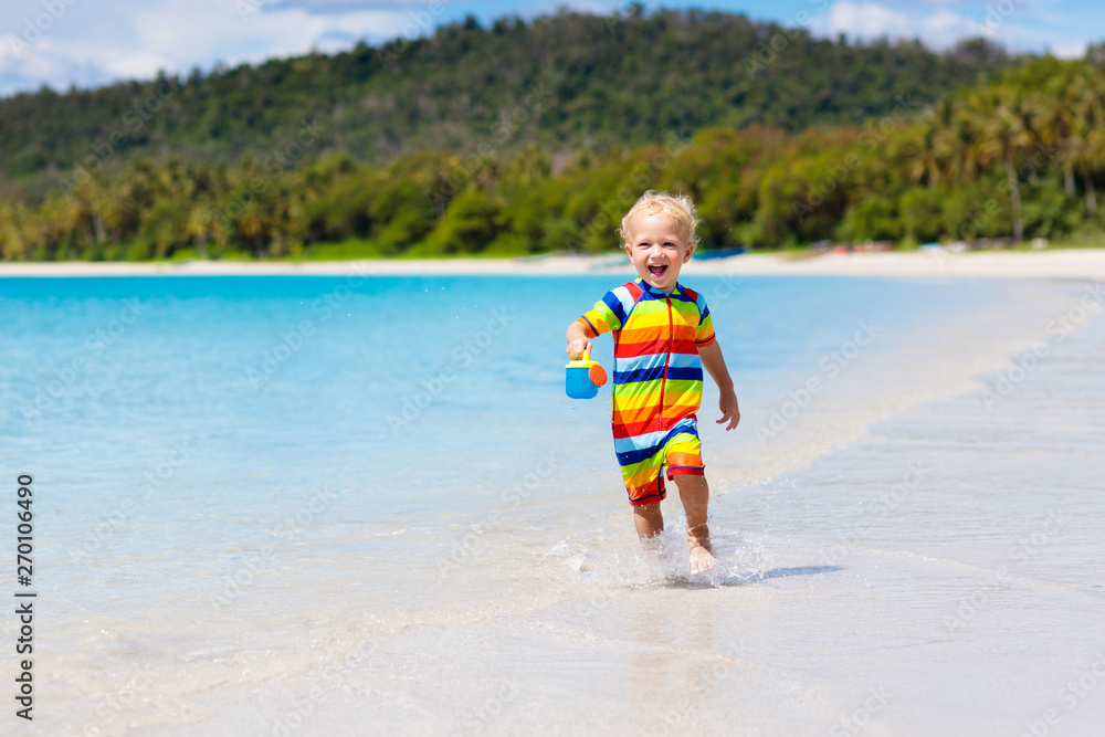 Kids play on tropical beach. Sand and water toy. Kids play on tropical beach. Sand and water toy.