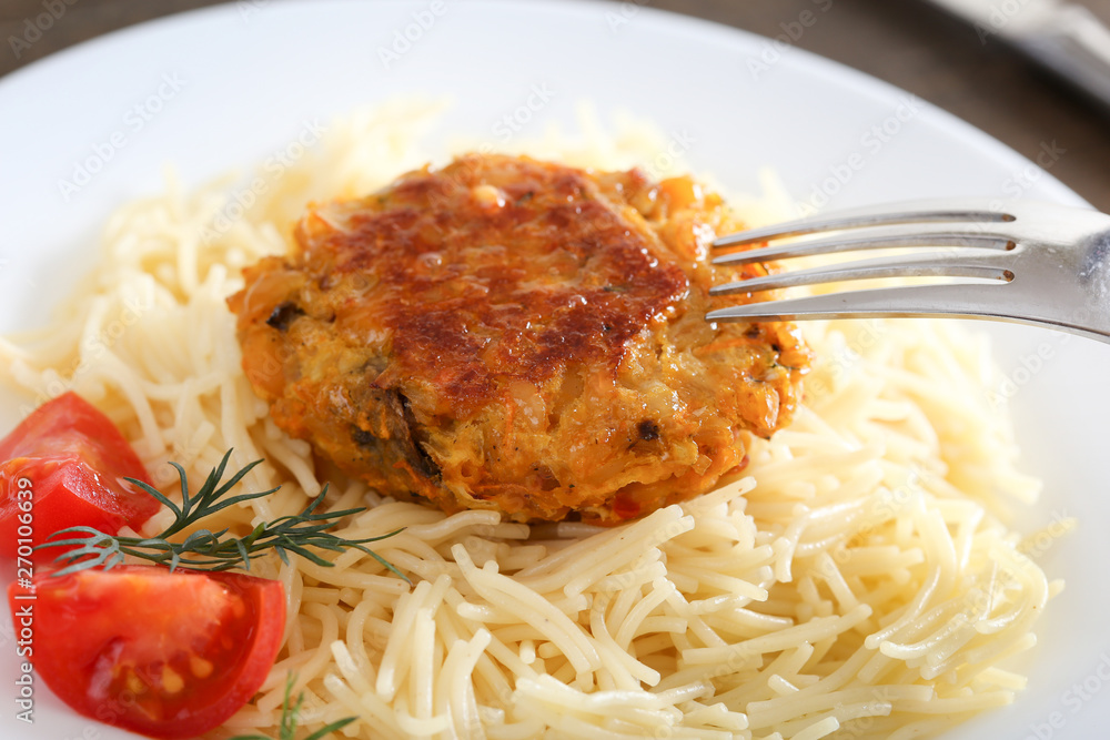 Chickpea cutlet and pasta on a white plate Chickpea cutlet and pasta on a white plate