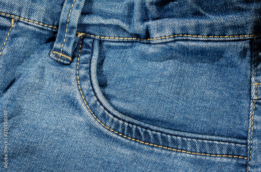 Light blue jeans front pocket detail background Light blue jeans front pocket detail background