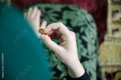 Young Muslim woman praying in the mosque photo