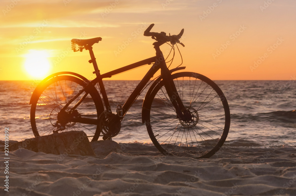 Bike and sunset by the sea. Black bike by the sea. Bike and sunset by the sea. Black bike by the sea.