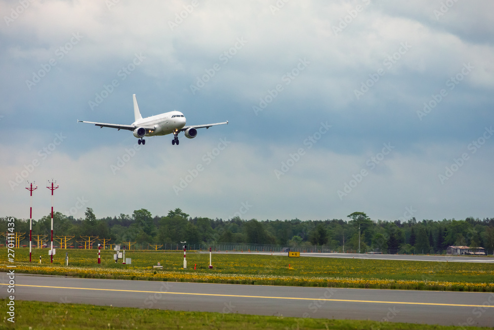 white passenger plane lands at the airport white passenger plane lands at the airport